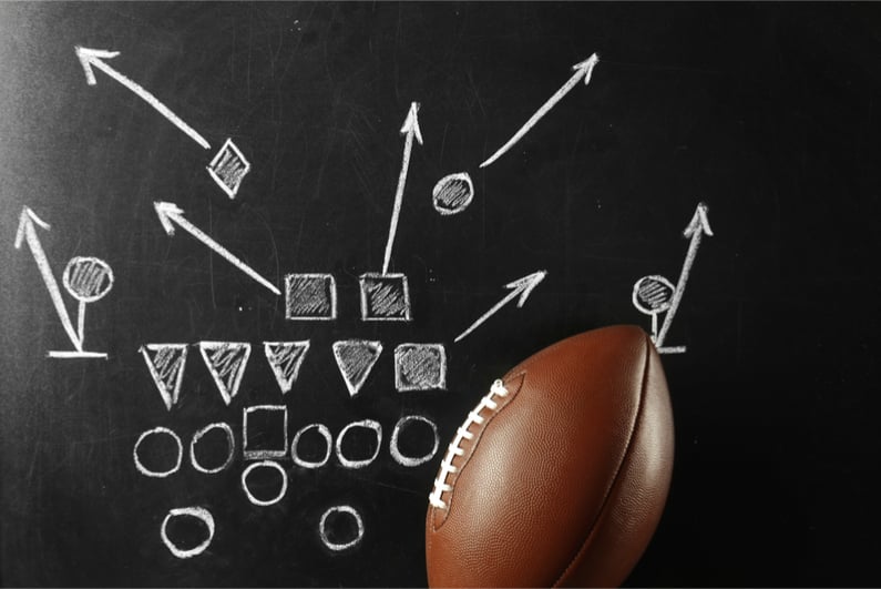 American football defense diagram in chalk on blackboard