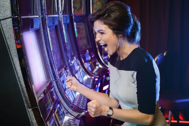 Happy woman playing slots