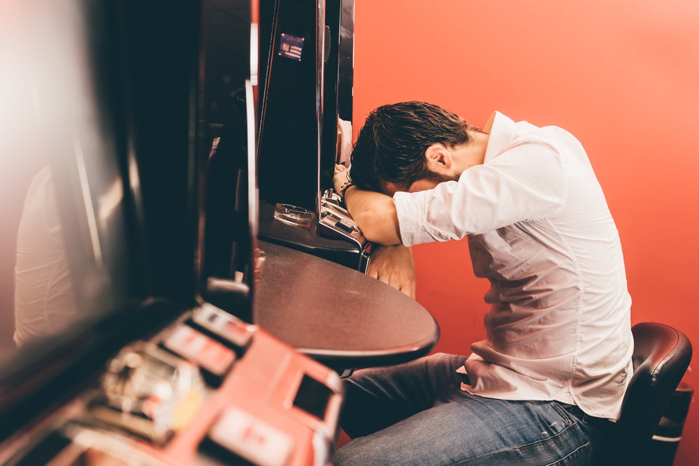 man losing at slot machines