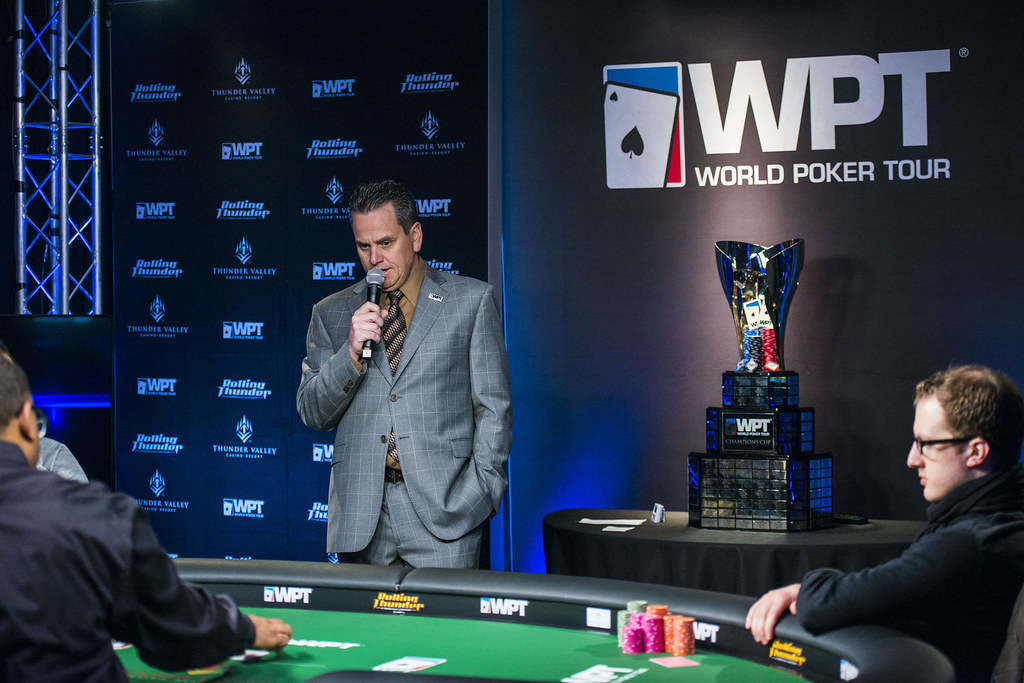 man in suit delivering a speech at a poker tournament