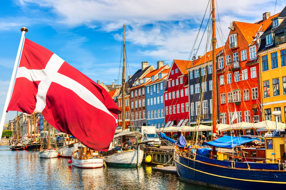 flag of Denmark with Copenhagen scene in the background