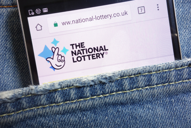 National Lottery website displayed on smartphone hidden in jeans pocket