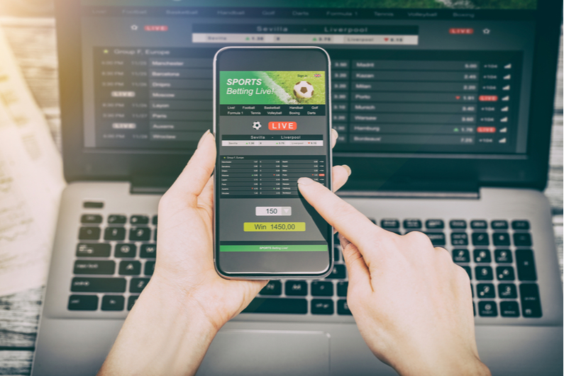 sports betting on phone and laptop