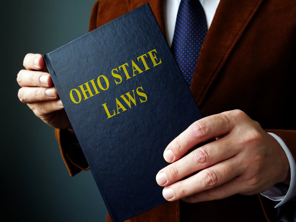 Man holding Ohio State Laws book