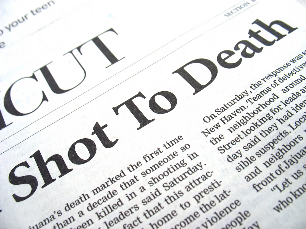 newspaper headline reads "shot to death"