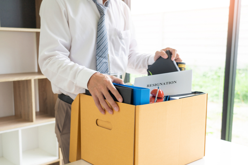 Businessman packing his things in office