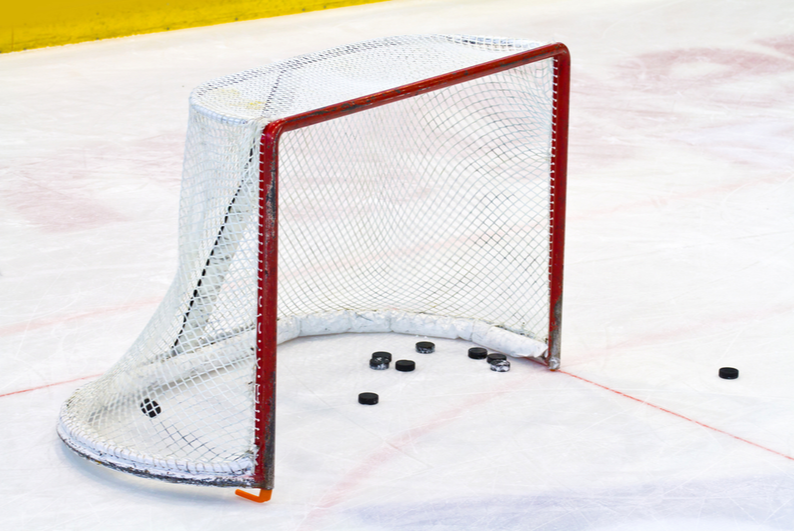 Pucks in an empty ice hockey net