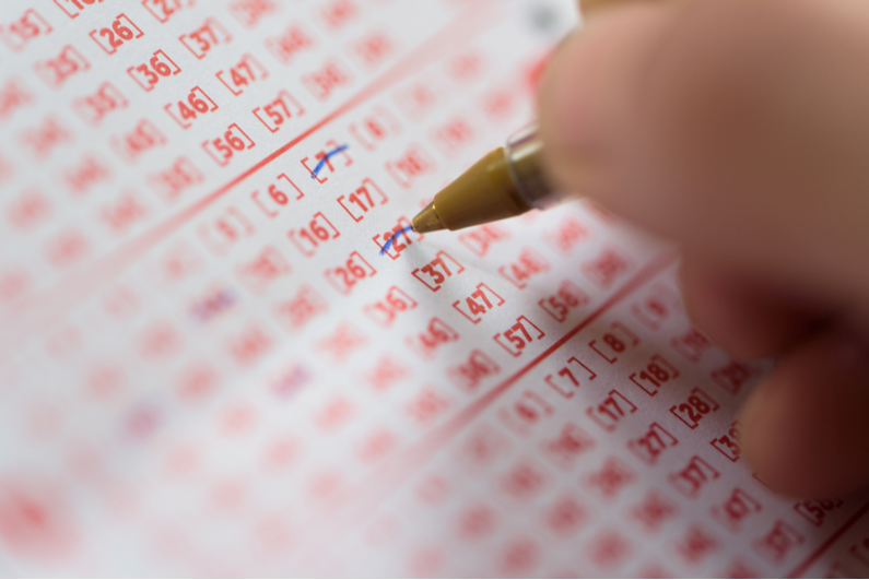 Person picking numbers on a lottery ticket