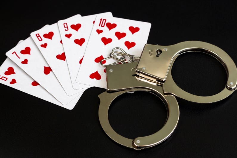 handcuffs and playing cards